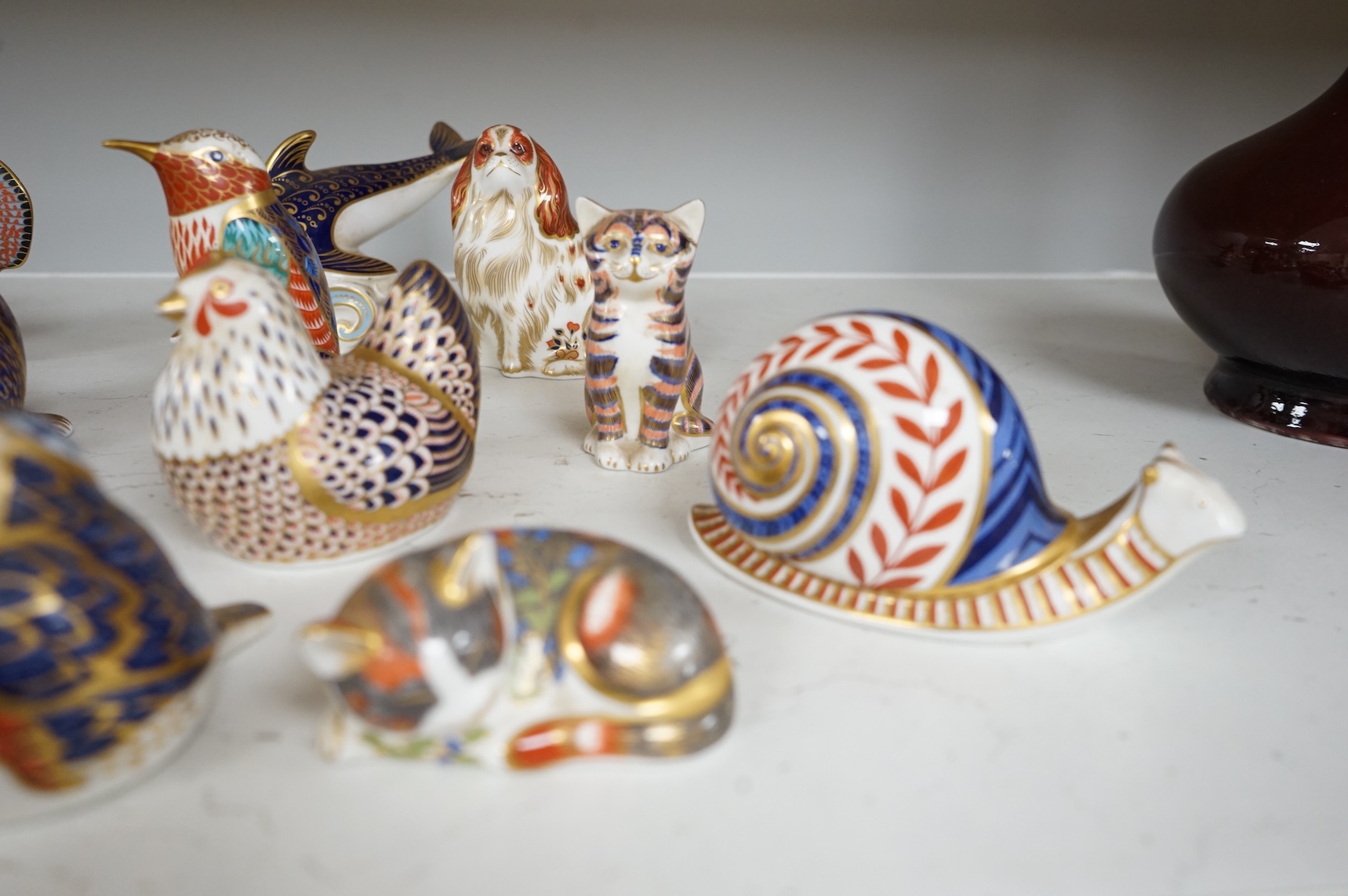 A collection of Royal Crown Derby Imari animal paperweights to include cats, fish and birds, largest 14cm high